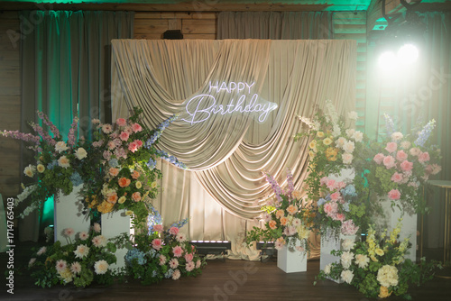 Celebratory birthday setup with elegant floral decorations and warm lighting