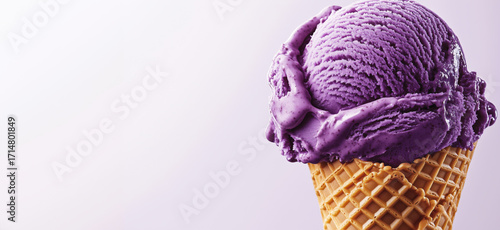 Delicious purple ice cream scoop in waffle cone with soft texture and vibrant color, detailed image