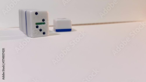 dominoes colliding on a white background