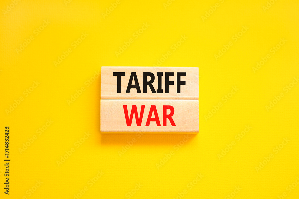 Naklejka premium Trade tariff war symbol. Concept word Tariff war on beautiful wooden blocks. Beautiful yellow paper background. Business trade tariff wars concept. Copy space.