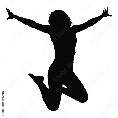 A joyful woman leaping with arms raised in a dark silhouette