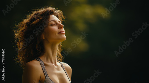 woman is practicing breathing exercise while gazing upwards against clean light background