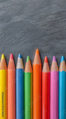 Colorful Pencils Arranged on a Chalkboard Background Suitable for Art Project...