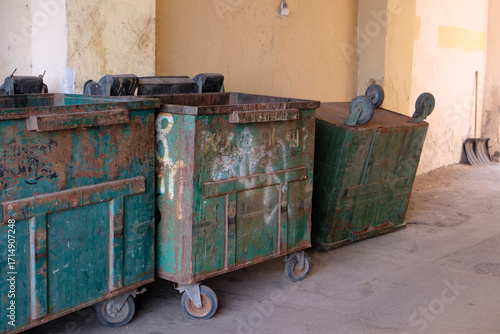 trash bins near the wall of the building