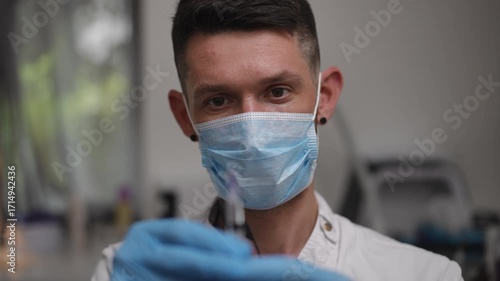 A confident healthcare worker expertly showcases a syringe, thoroughly prepared for an upcoming medical procedure