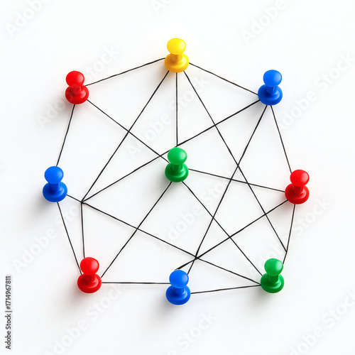 Colored push pins connected with thread network on white background
