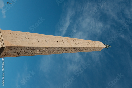 Lateran Obelisk in Piazza San Giovanni in Laterano Rome under blue sky ancient Egyptian granite monument with Latin base inscriptions city square landmark travel Italy. High quality photo