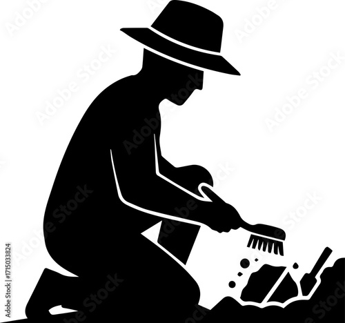 Dedicated archaeologist unearthing ancient artifacts with brush and trowel in a historical dig site
