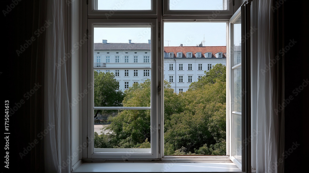 Fototapeta premium Traditional Copenhagen apartment window overlooking peaceful tree-lined courtyard below.