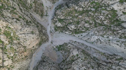 Wallpaper Mural Morning light reveals a highland ravine, jagged rock wall and sparse alpine meadow in Ugam-Chatkal, Uzbekistan. Western Tian Shan geology with dry stream bed and wild terrain ideal for adventure Torontodigital.ca
