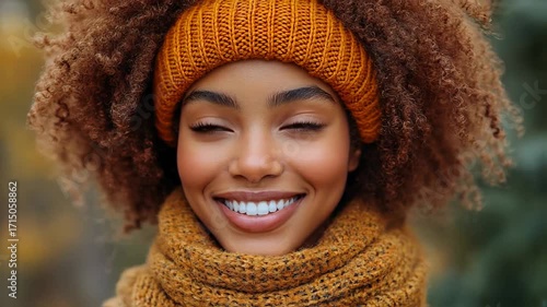 Radiant portrait of a smiling woman in autumn knitwear outdoors.