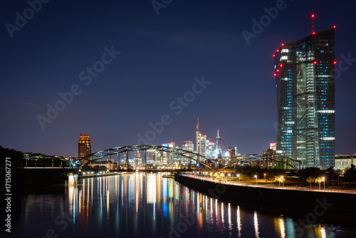 Frankfurt City Skyline at Night with Illuminated Skyscrapers and River Reflections