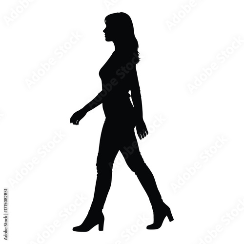 A woman walking with a confident stride a striking black silhouette