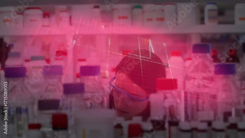 Woman scientist peeking through goggles reading lab labels with red overlays as colleague joining