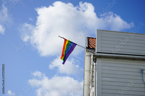 Rainbow pride flag on a white wooden house in Norway.