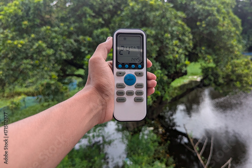 Air Conditioner (AC) remote controller on hand