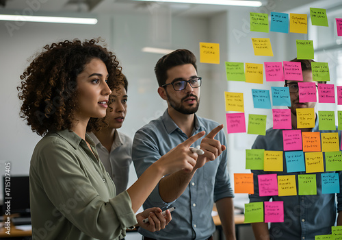 Creative Team Brainstorming Ideas on a Glass Wall with Sticky Notes