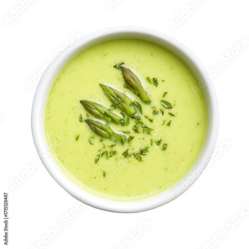 Top - down view of creamy pale green asparagus soup in a white bowl garnished with asparagus spears and fresh herbs Healthy and delicious