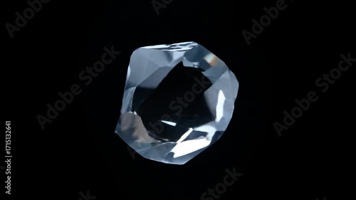 Clear crystal spinning slowly in black space  