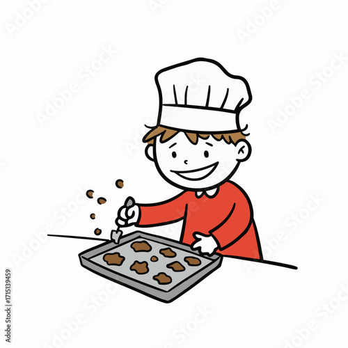 A cheerful young boy wearing a chef's hat decorates cookies on a baking sheet.