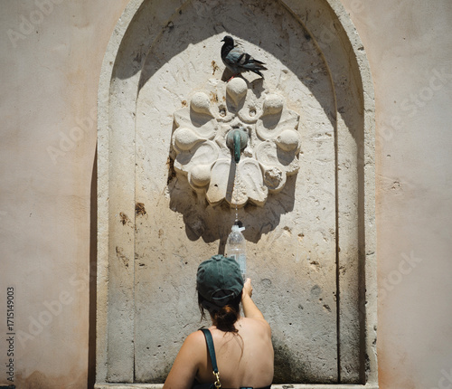 Dubrovnik, Croatia, 27th July 2025, person filling water bottle from a public drinking water fountain