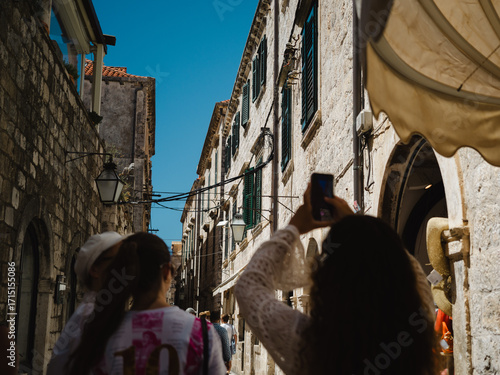 Dubrovnik, Croatia, 28th July 2025, tourists taklig photographs view of alleyways and rooftops