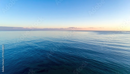 Aerial Seascape View Featuring a Tranquil Ocean Under Clear Blue Sky at Daytime Wide Angle Landscape Shot