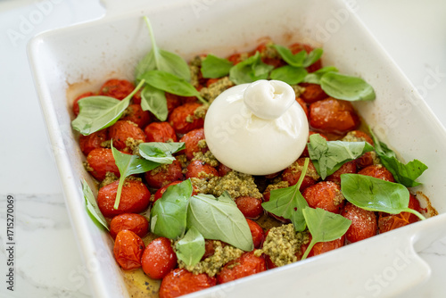 roasted cherry tomatoes and mozzarella burrata cheese and basil