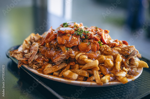 Photography A hearty plate of loaded poutine topped with shredded meat and gravy showcases a rich mix of textures and flavors