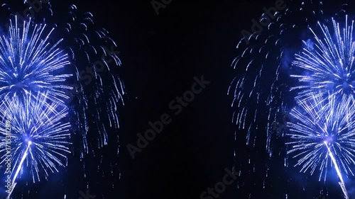 Radiant blue and purple fireworks sparkling on the sides of a dark background