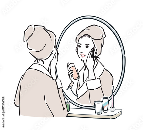 鏡の前に立つバスローブ姿の女性　スキンケア