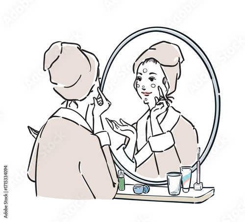 鏡の前に立つバスローブ姿の女性　スキンケア