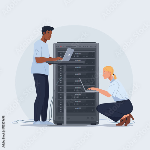 Two people working on servers with laptops in a data center.