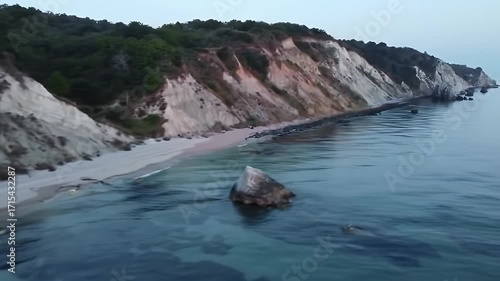 Tranquil coastal scenery showcasing a dramatic white cliff face meeting the calm sea.