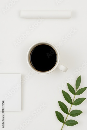 Minimal flat lay composition with cup of black coffee, fresh green leaves, rolled white paper and clean workspace background, perfect for creative design, branding or lifestyle concept