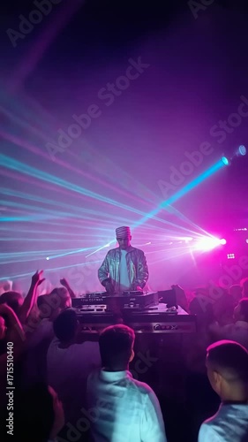 DJ on stage with dancing crowd and purple laser lights, energetic night party and music celebration atmosphere