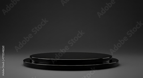 A sleek, black, circular, two-tiered podium on a dark gray studio background for product presentation.