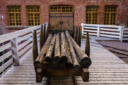 Wooden logs stacked on an old railroad cart outside Verla Mill Museum in Jaala, FInland