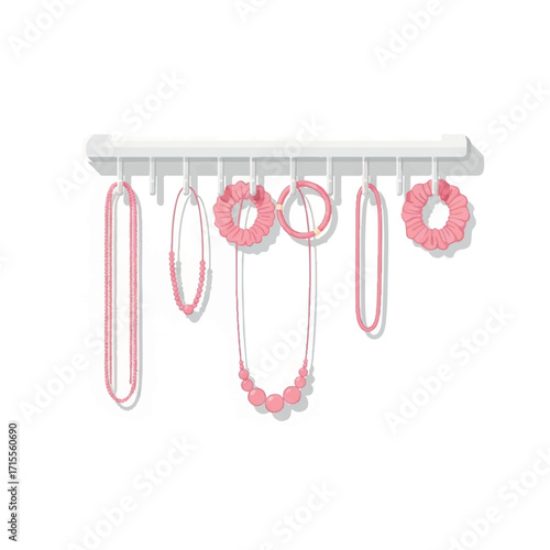 A rack of pink jewelry including necklaces and earrings hangs against a white background in a flat lay composition with soft pastel tones.