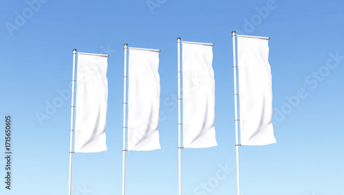 Four white flags are on poles in the sky