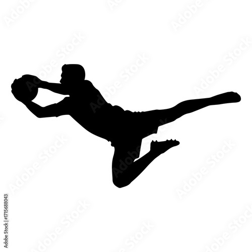Silhouette of a soccer goalkeeper jumping to catch the ball