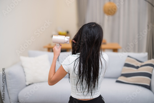 Woman Dry Her Hair with Hair Dryer