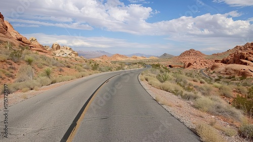 Desert road scenery Arid Serenity: Breathtaking Desert Road Scenery – A Long, Winding Asphalt Road Stretching Through Golden Sand Dunes and Scattered Desert Shrubs, Under a Clear Blue Sky