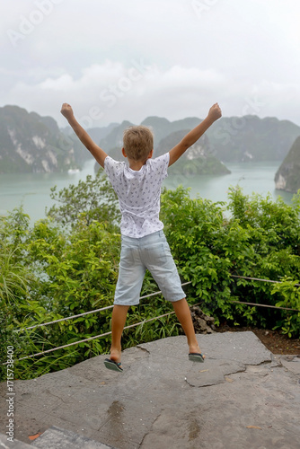 Happy european family, visiting Ha Long bay on a cruise with pool, visiting caves and landview points
