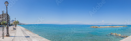 Blue, calm mediterranean sea at the promenade of Xylocastro, gulf of Corinth, Peloponnes, Greece (panorama)