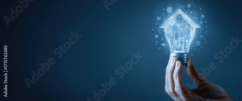 Hand holding a glowing light bulb shaped like a house representing innovation and new beginnings.