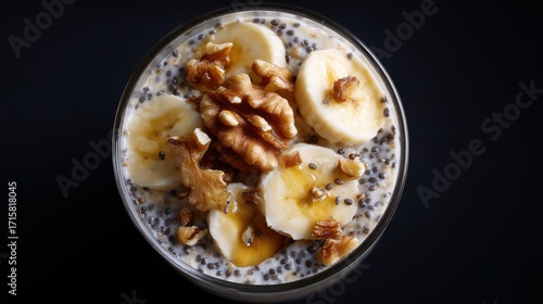 Wallpaper Mural moody top view of overnight oats topped with bananas, walnuts, chia seeds, and drizzle of honey Torontodigital.ca