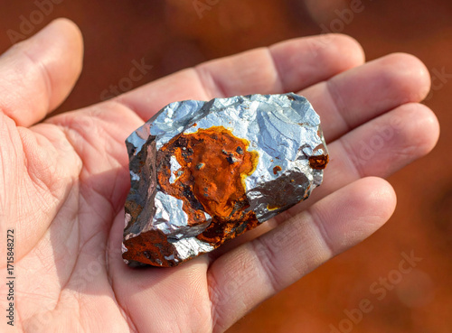 Human Hand with Bauxite Ore Sample