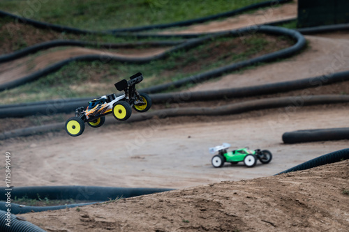 Photography Radio-controlled car jumping on a dirt track during a race competition