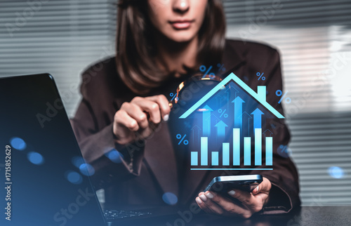 Fotografie Businesswoman analyzing real estate interest rate trends using d